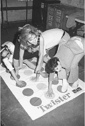 Teens enjoy playing the game Twister. Corbis Corporation. Reproduced by permission.