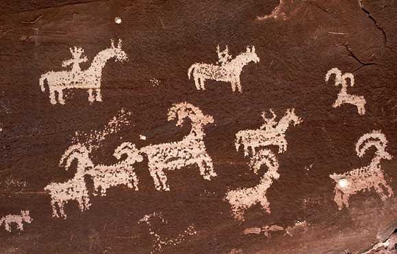 Drawings on a rock in Utah show the Ute hunting elk on horseback.