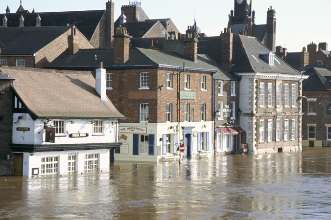 A flooded street in England. Floods can cause a great deal of property damage.