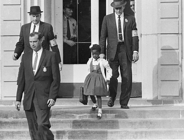 U.S. Deputy Marshals escort six-year-old Ruby Bridges, the only black child enrolled in William Frantz Elementary School, in New Orleans, Louisiana, in 1960.