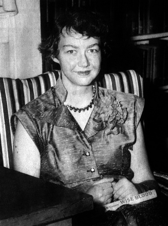 American writer Flannery O'Connor (1925-1964) with her book Wise Blood in 1952.