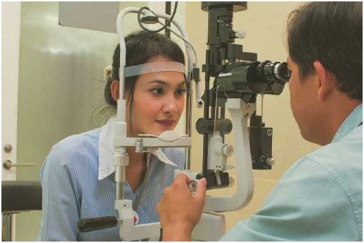 An ophthalmologist examines a patient's eyes.