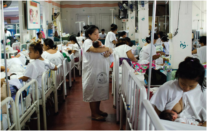 Indigent mothers tend to new born infants at a government-run hospital ward on August 11, 2014, in Manila, Philippines. The Philippines has one of the fastest-growing populations in Southeast Asia with around 100 million people. At least 12 million people live in the capital city of Manila alone, making it one of the most densely populated and largest cities in the world. Lack of space and economic opportunities has pushed around 4 million people to live informally along waterways, bridges, and even cemeteries, further straining the already weak infrastructure and limited resources of the city.