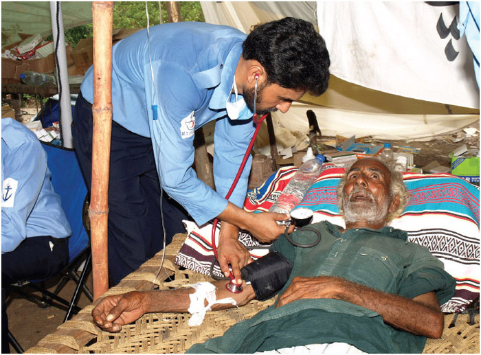 An elderly man is treated at a relief camp established by the Pakistani navy for flood-displaced victims after a flood hit Sind Province in Pakistan. The elderly are one group considered vulnerable, and they may be at increased risk during events such as natural disasters.