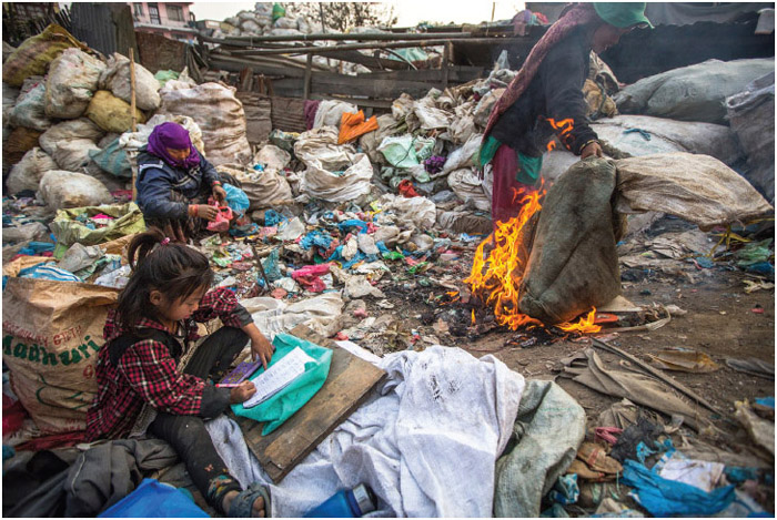A child does her homework while her family works at a landfill in Kathmandu, Nepal. Nepal is one of the poorest countries in the world, with more than one-third of children living below the national poverty level in 2010, according to the United Nations Children's Fund.