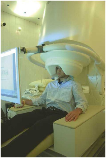 Male patient undergoing an MEG (magnetoencephalography)