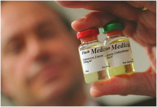 A man holds two vials of anabolic steroids, which are typically used to increase muscle mass and thereby enhance an athlete's performance.