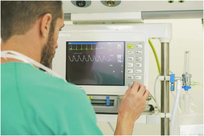 A nurse examines the electrical activity of a patient's heart on an electrocardiogram (EKG) machine. EKGs can detect problems with the heart by monitoring how fast or slow it's beating or if the heartbeat is weak or irregular.