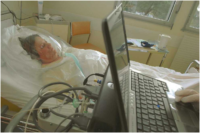 A doctor at the Cardiologic Hospital of Haut-Lévêque in Bordeaux, France, performs indirect calorimetry on a patient to measure inhaled levels of oxygen and exhaled levels of carbon dioxide.
