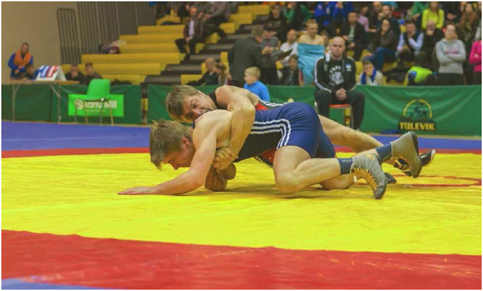 A wrestler tries to pin his opponent to the mat. Wrestling requires a great deal of body and cardiovascular strength; individuals who want to wrestle professionally are also trained in technique at special wrestling schools.