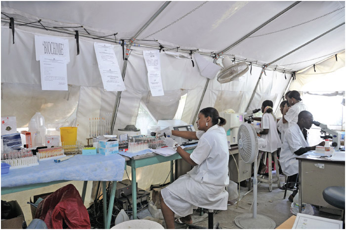 Health workers of an hospital working under difficult condition in a makeshift tent on August 26, 2010 in Port-Au-Prince, Haiti.