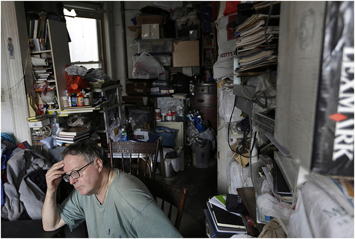 An extreme hoarder sits in his apartment in New York City in 2016, with floor-to-ceiling stacks of clutter. According to the DSM-5, extreme hoarding represents a type of obsessivecompulsive disorder related to other forms of anxiety disorders.