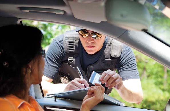 When a police officer stops a woman to give her a traffic ticket, he examines her driver's license. In some cases, the officer may also ask to see the detainee's immigration papers.