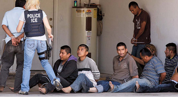 An ICE officer arrests suspected undocumented immigrants.