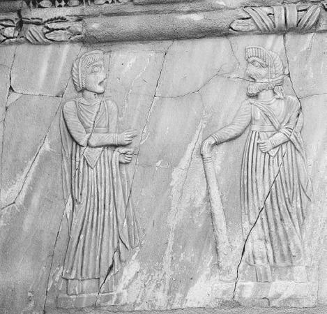 Roman stone relief of actors wearing masks from Sabrata (in modern day Libya), post 4th-century B.C.E. THE ART ARCHIVE.
