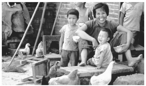 A mother and her children in a farming commune in Canton. Only ethnic minority families are allowed to have more than one child.