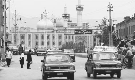 Vehicles travel on a street near the Eman Reza Shrine in Mashhad.