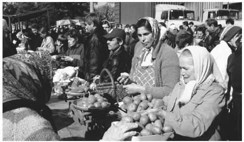 Traders sell food at a Sunday market in Kiev. A marketplace is the centerpiece of almost every town and village.