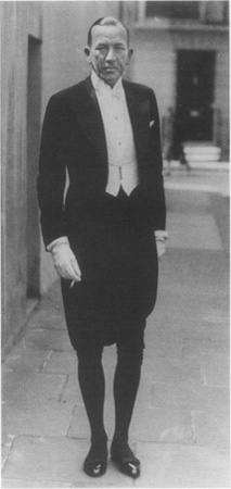 Noel Coward as he prepares to leave his home for a royal function at St. Jamess Palace, London, 1937