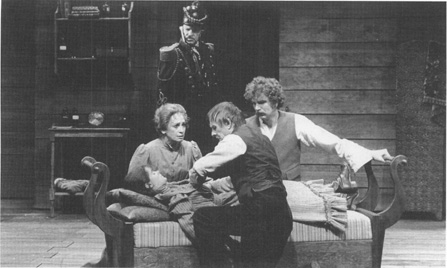 In a scene from a 1979 production of The Wild Duck at Londons Olivier Theatre, Old Ekdal (in uniform) looks on while Dr. Relling, Gina Ekdal, and Hjalmar Ekdal attend to Hedvig Ekdal