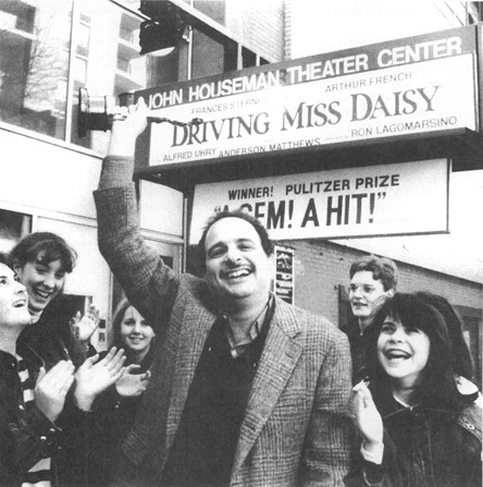 Alfred Uhry standing beneath a marquee promoting his Pulitzer Prize-winning play, Driving Miss Daisy.