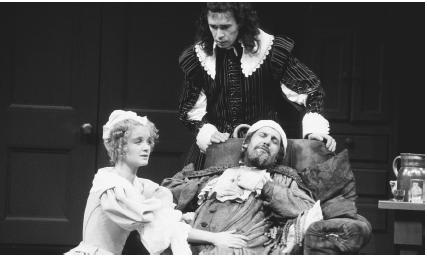 Emily Morgan, Clive Arrindell, and Daniel Massey in a scene from the 1981 stage production of The Hypochondriac, a translated version of the The Imaginary Invalid, performed at the Olivier Theatre in London.