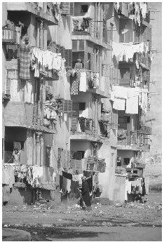 Tenement housing in Cairo, Egypt. Estimates of Cairo's population vary from 8 to 12 million as of 2003. A population explosion that began in 1952 has resulted in overcrowding, scarce housing, unemployment, and health concerns. © TOM NEBBIA/CORBIS. REPRODUCED BY PERMISSION.