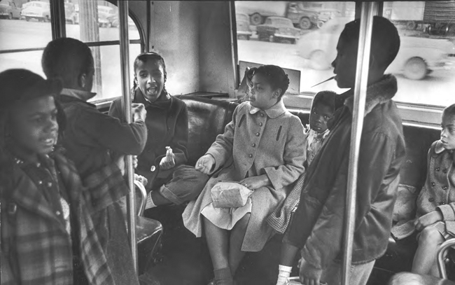 In March 1953, Linda Carol Brown (center) sits on a bus as she rides to her racially segregated elementary school in Topeka, Kansas. Eight-year-old Brown was the plaintiff in the celebrated Supreme Court case that declared racially segregated s
