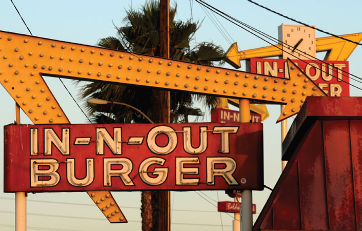 In-N-Out Burger signs fill the skyline in Baldwin Park, California, in June 2010. Amid complaints of obesity and lines of idled cars stretching into neighborhood streets, this blue-collar town is banning new drive-throughs in hopes of shedding 