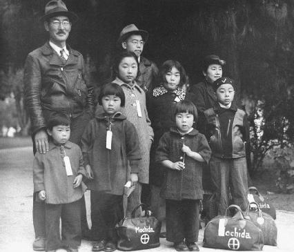 A Japanese American family with their belongings waiting for internment