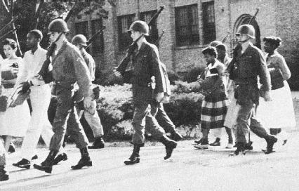 Federal troops escort nine black students to Little Rock High School, Arkansas, 1957, after the 1954 U.S. Supreme Court ruling ordering integration of public schools