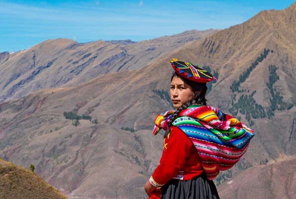  A Quechua girl in traditional clothing stands near the Andes Mountains in Peru. Most of Peru's indigenous people speak Quechua, a form of the same language spoken by the Inca.