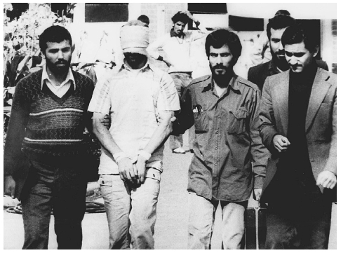 PRIMARY SOURCE: Americans Held Hostage in Iran A bound and blindfolded American hostage is displayed to the crowd outside the U.S. Embassy in Tehran, November 9, 1979. APWIDE WORLD PHOTOS