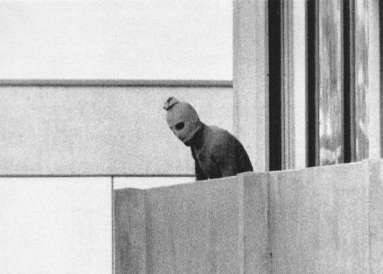 TV cameras catch a member of the terrorist group that took eleven Israeli athletes hostage during the 1972 Summer Olympics.