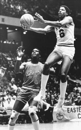 Defying gravity, Julius "Doctor J" Erving goes up for a basket. Reproduced by permission of AP/Wide World Photos.