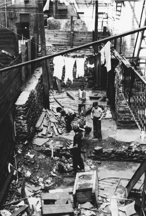 Kids playing in an alley in the New York City slums. Reproduced by permission of AP/Wide World Photos.