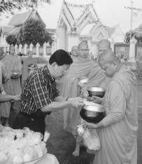Buddhist monks receive alms from laypeople in Thailand, Monks may receive all of their food in alms, and eat only what they are given. For the laypeople, giving alms is a way to build merit.