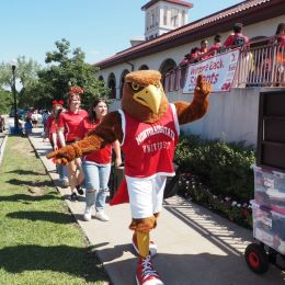 Rocky the Red Hawk Greets Students
