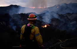 A Firefighter Watches a Wildfire Burn in Topanga State Park in California