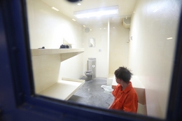A 12-year-old Boy Sits in his Cell